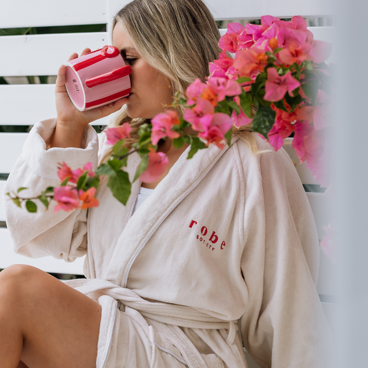 Woman wearing white 100% cotton bathrobe with pink flowers - Robe Society